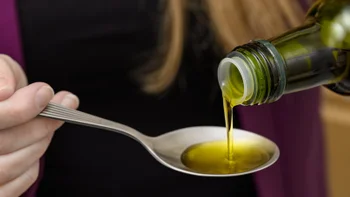 Diet and nutrition: closeup spoonful olive oil 2233637248