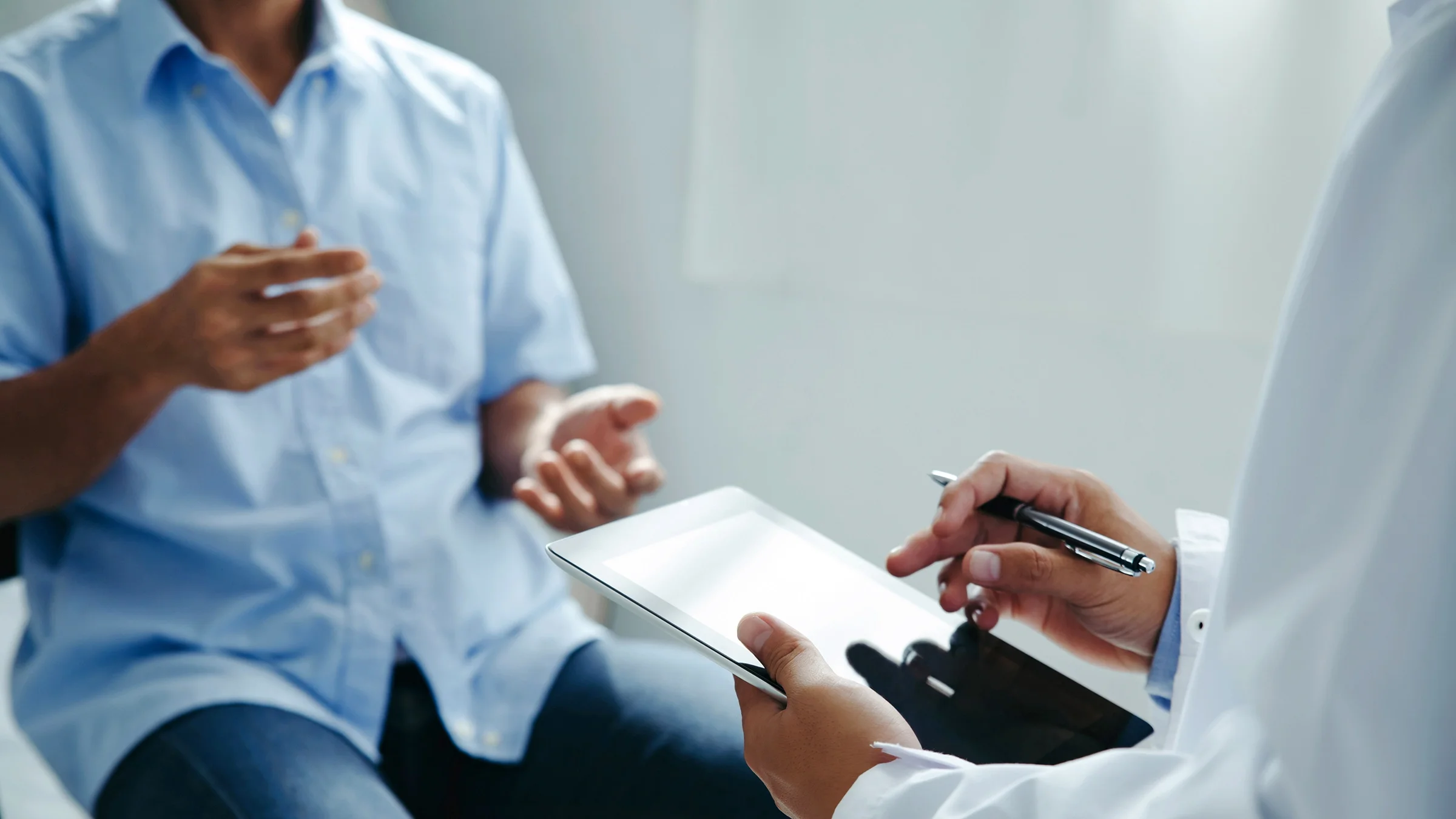 A doctor discusses treatment with a patient.