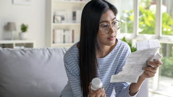 Linzess: woman reading medicine pamphlet 1477349799
