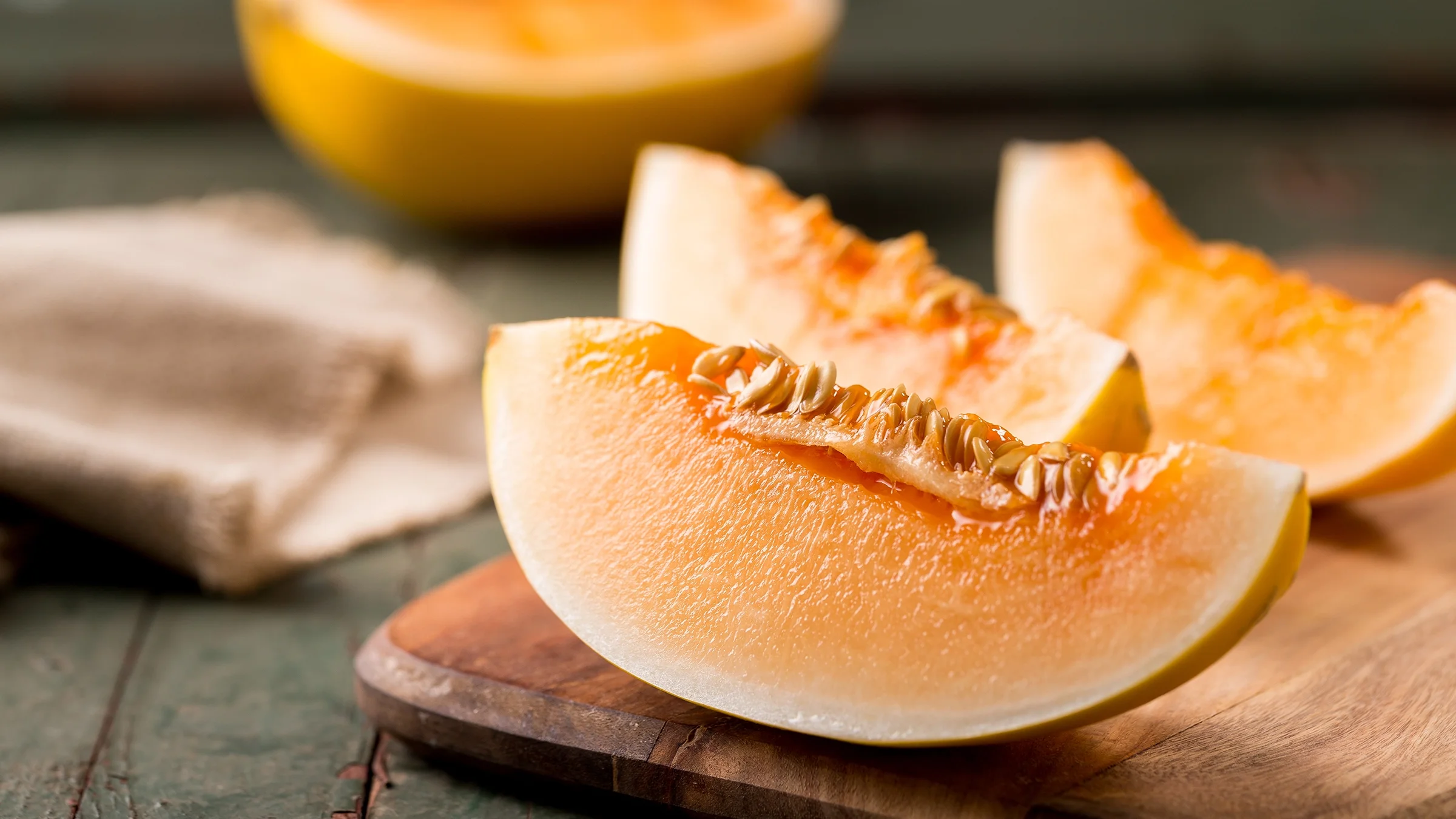 Sliced ripe cantaloupe melon on a cutting board