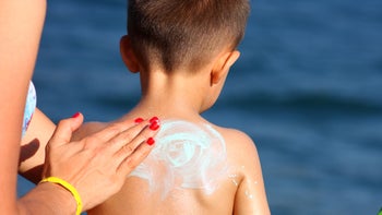 Dermatology: Sun safety for kids: mother applying sunscreen to child lake-184339377
