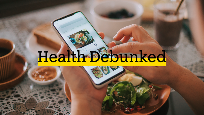 Close-up of a person using a calorie counter app during a meal. There is added text on top reading “Health Debunked” with a yellow highlight bar behind it.