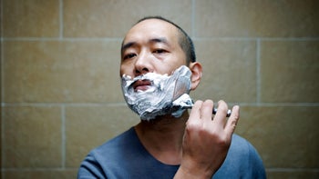dermatology: man shaving with razor 1450032825