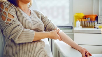High cholesterol: holding cotton after blood test 1183904797