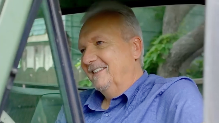 Ed Doyle is pictured sitting in his pickup truck.