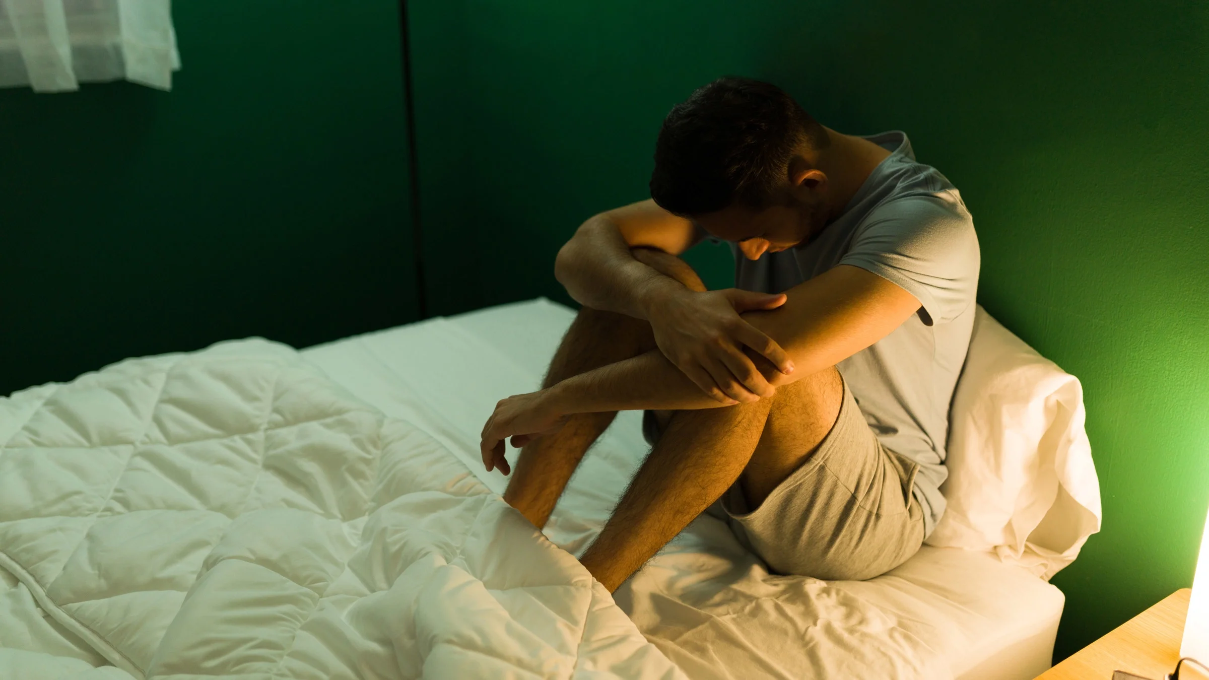 A sad person in bed.