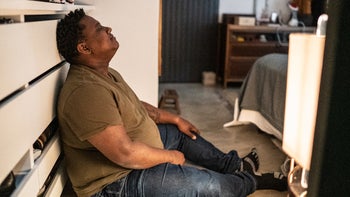 anxiety-disorder: man sitting on bedroom floor 1435656795