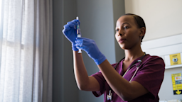 A healthcare worker measures out a dose for an injection.
stockstudioX/iStock via Getty Images Plus