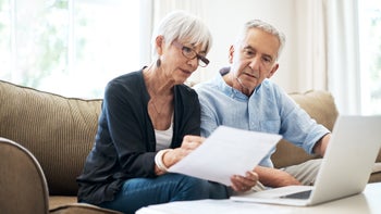 Medical debt: couple do finances at home 1053057434