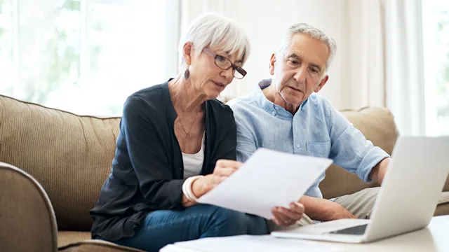 Medical debt: couple do finances at home 1053057434