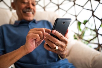Close-up of an older man using his smart phone while sitting at home.
andreswd/E+ via Getty Images