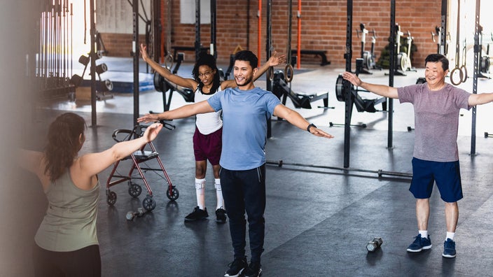 Fitness class doing arm circle exercise.