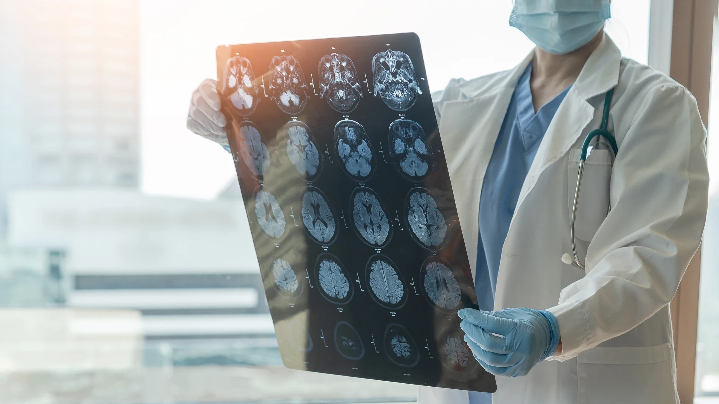 Cropped shot of a doctor reviewing brain scans.