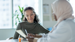 A teen discusses medication with a healthcare professional.
FatCamera/E+ via Getty Images 