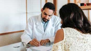 Neurological: doctor writing prescription for patient 1318281159