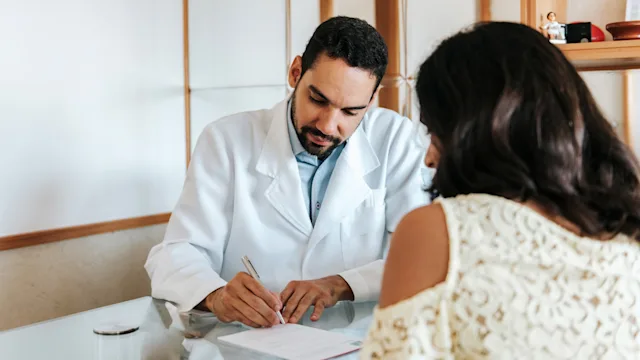 Neurological: doctor writing prescription for patient 1318281159