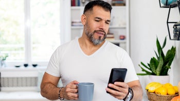 Erectile dysfunction: man reading phone at home 1450675795