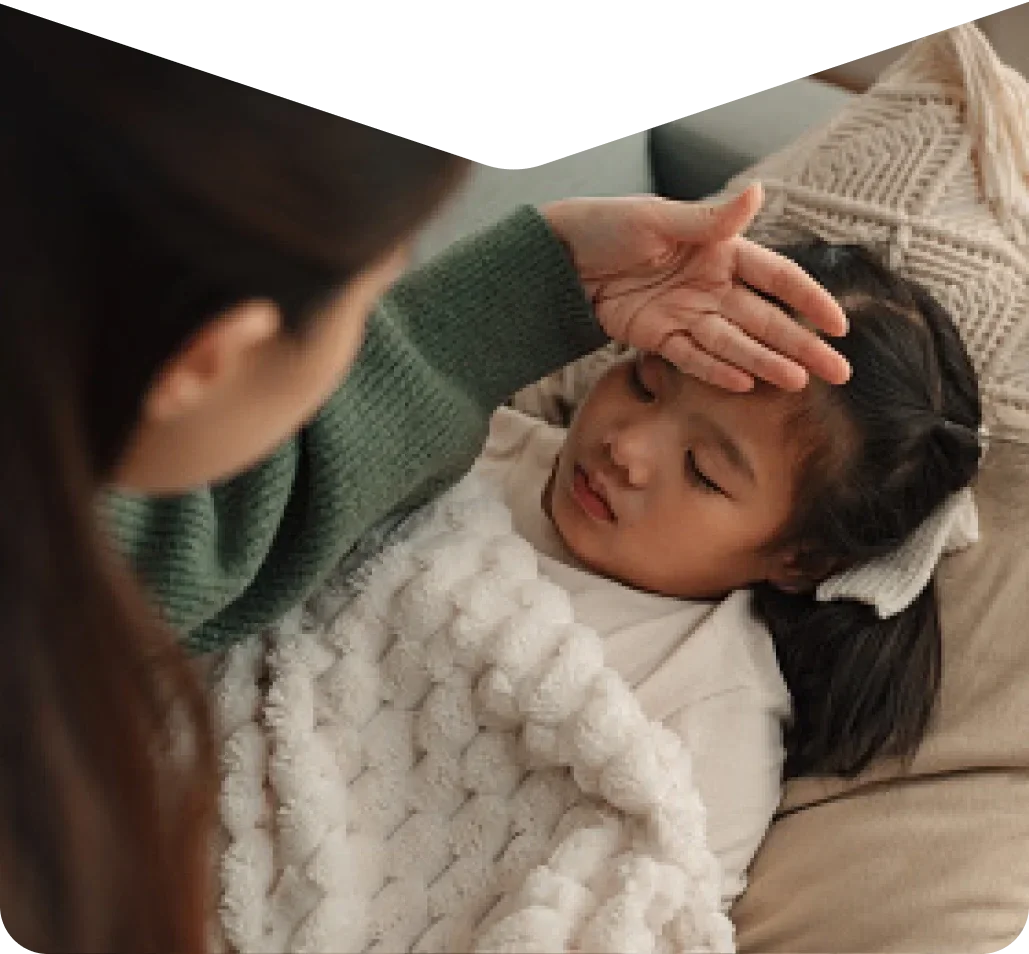 Mother feeling warm forehead of child