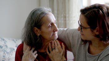 Senior Health: woman hugging elderly parent 1915738426