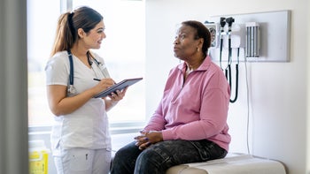 Patient advocacy: senior woman on exam table during appointment 2151967105