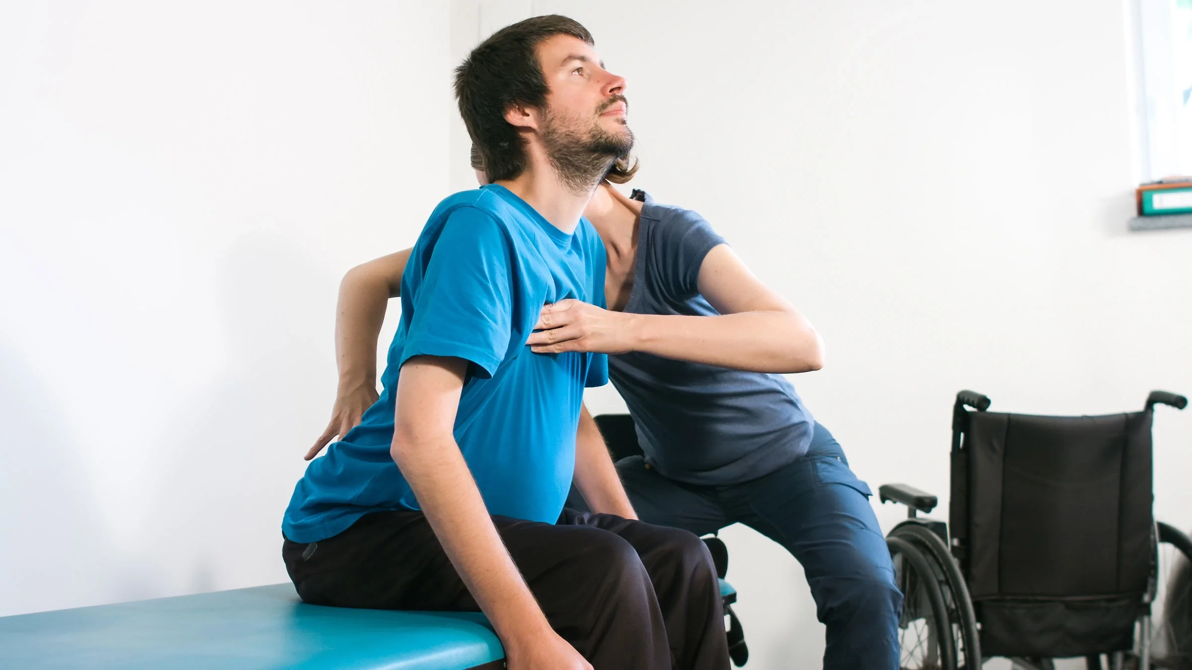 A man exercises during a physical therapy session with a healthcare provider. Muscular dystrophy can cause problems with movement. There are several treatment options for the condition that include physical therapy and medications.
