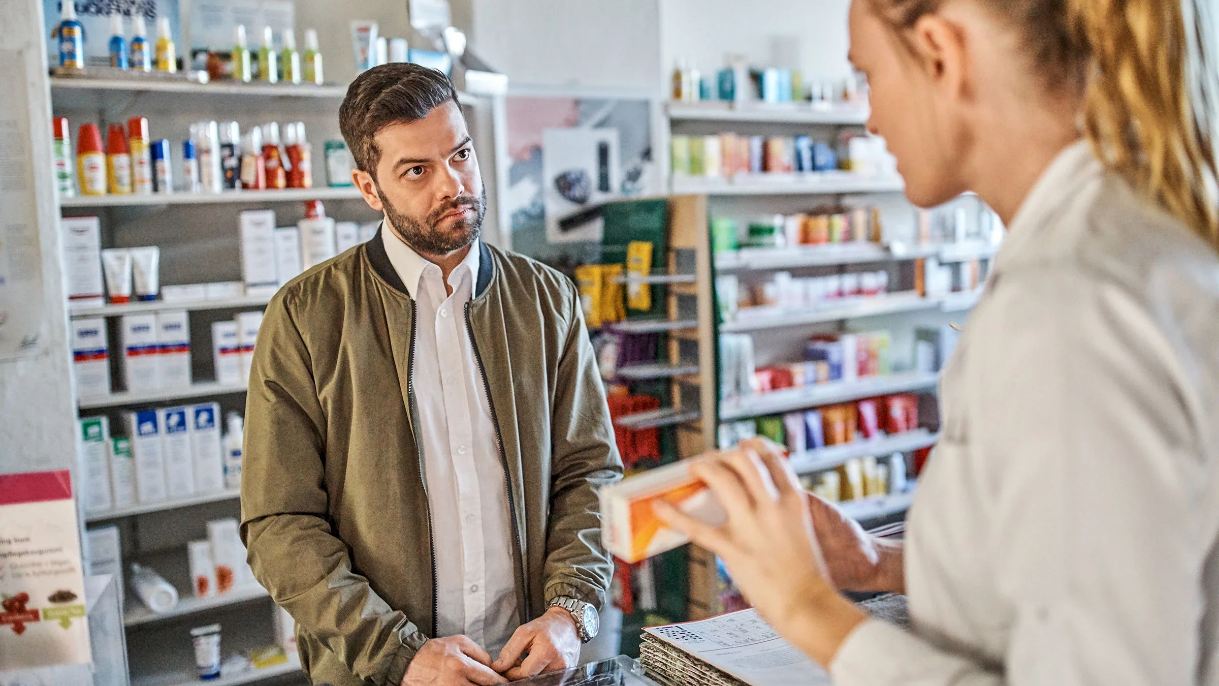 A man is asking a pharmacist about a cream.
Portra/E+ via Getty Images