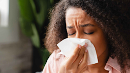 A woman blows her nose due to a cold.
Inside Creative House/iStock via Getty Images Plus