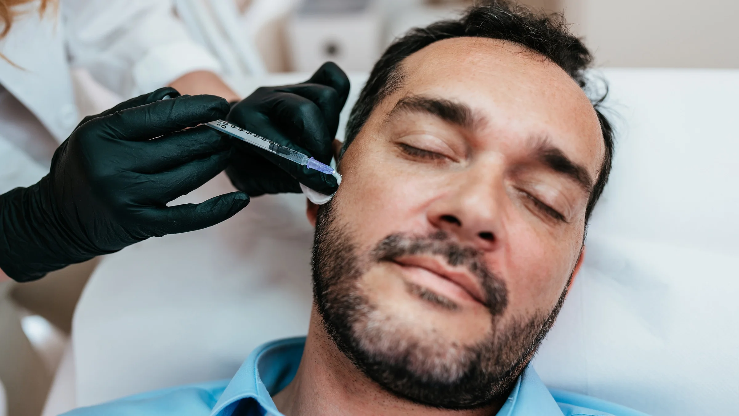 Man receiving botox injections.