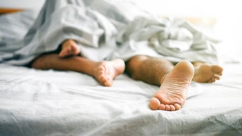 STDs: Warts: couples feet under covers-1179340142