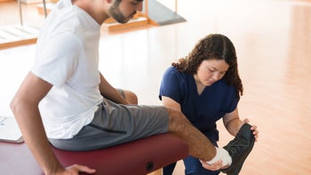 musculoskeletal: physical therapist treating foot 1132546212