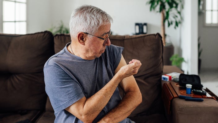 Man giving himself insulin injection in arm