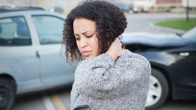 musculoskeletal-conditions: neck pain: woman holding neck after whiplash accident 892765508
