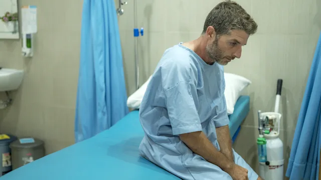 STDs: man hospital gown 1227555142