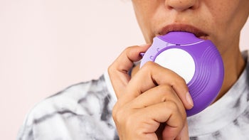advair: closeup using purple inhaler 1626842395