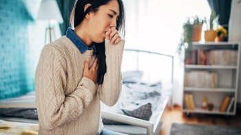 Cough: woman holding chest while coughing 1453203822