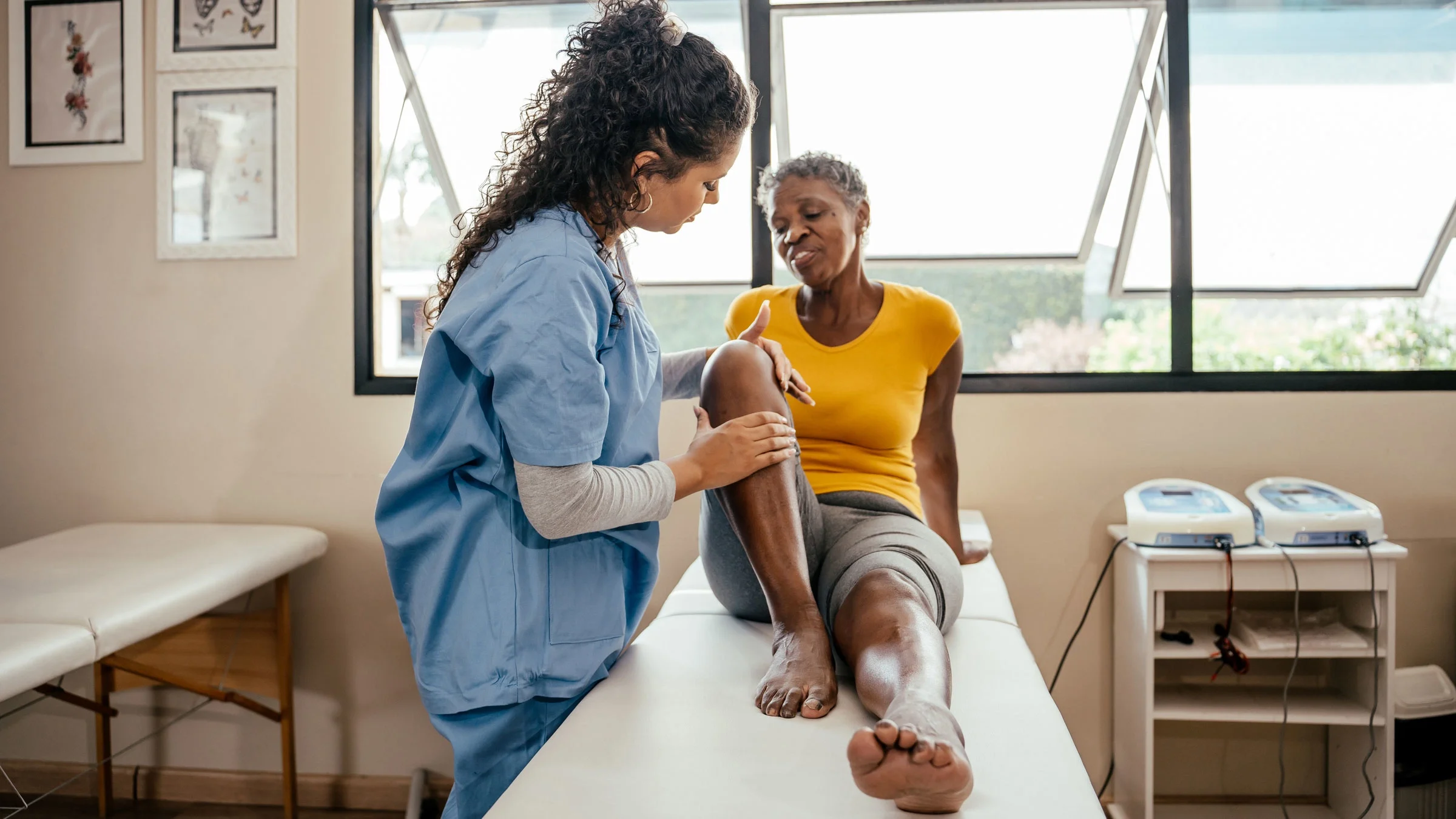 A doctor examining a patient's knee.