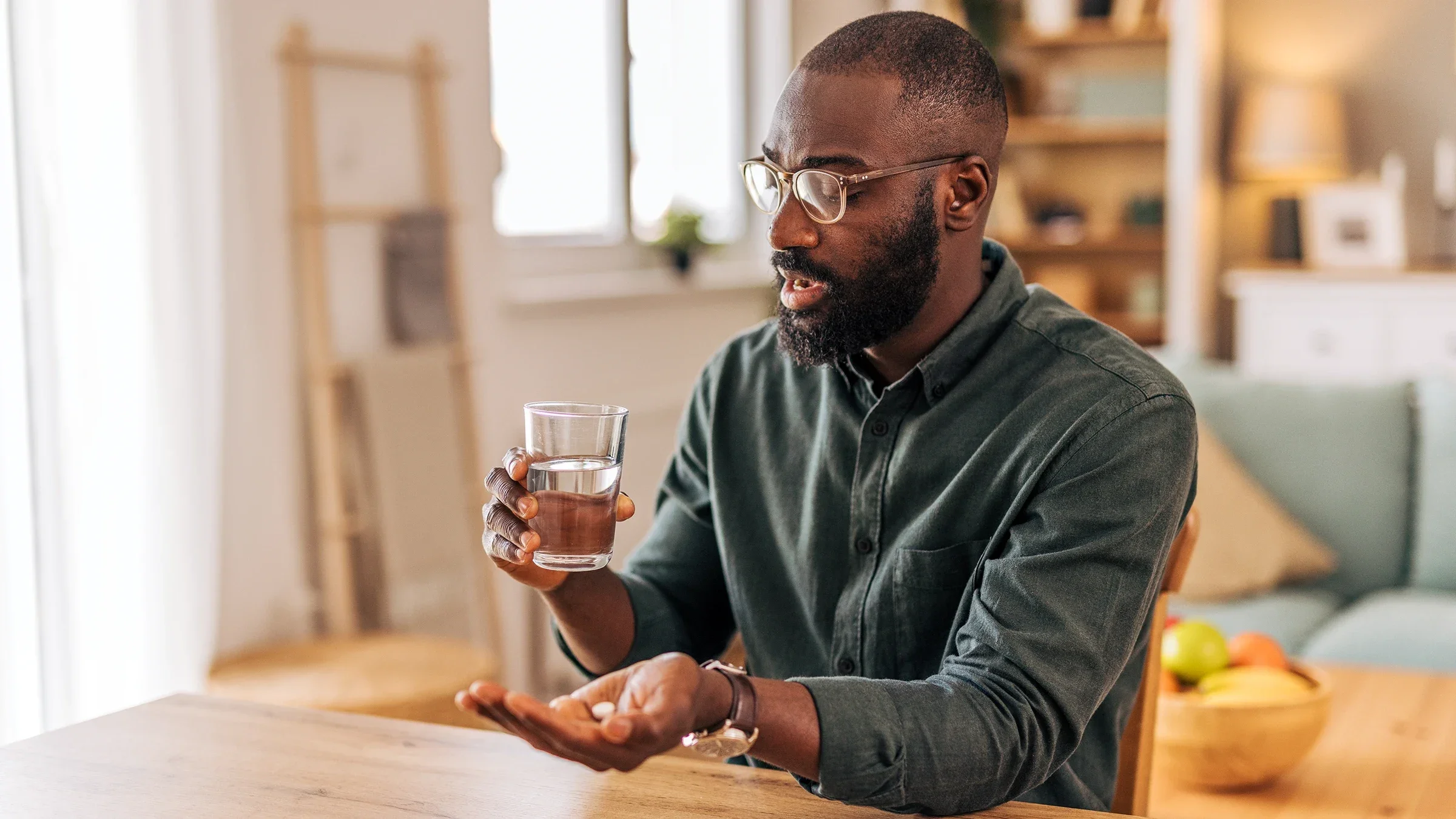 Man taking a pill with a glass of water
milorad kravic/E+ via Getty Images