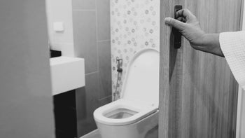 Health: Urinary tract infection: hand opening bathroom door-1128481078