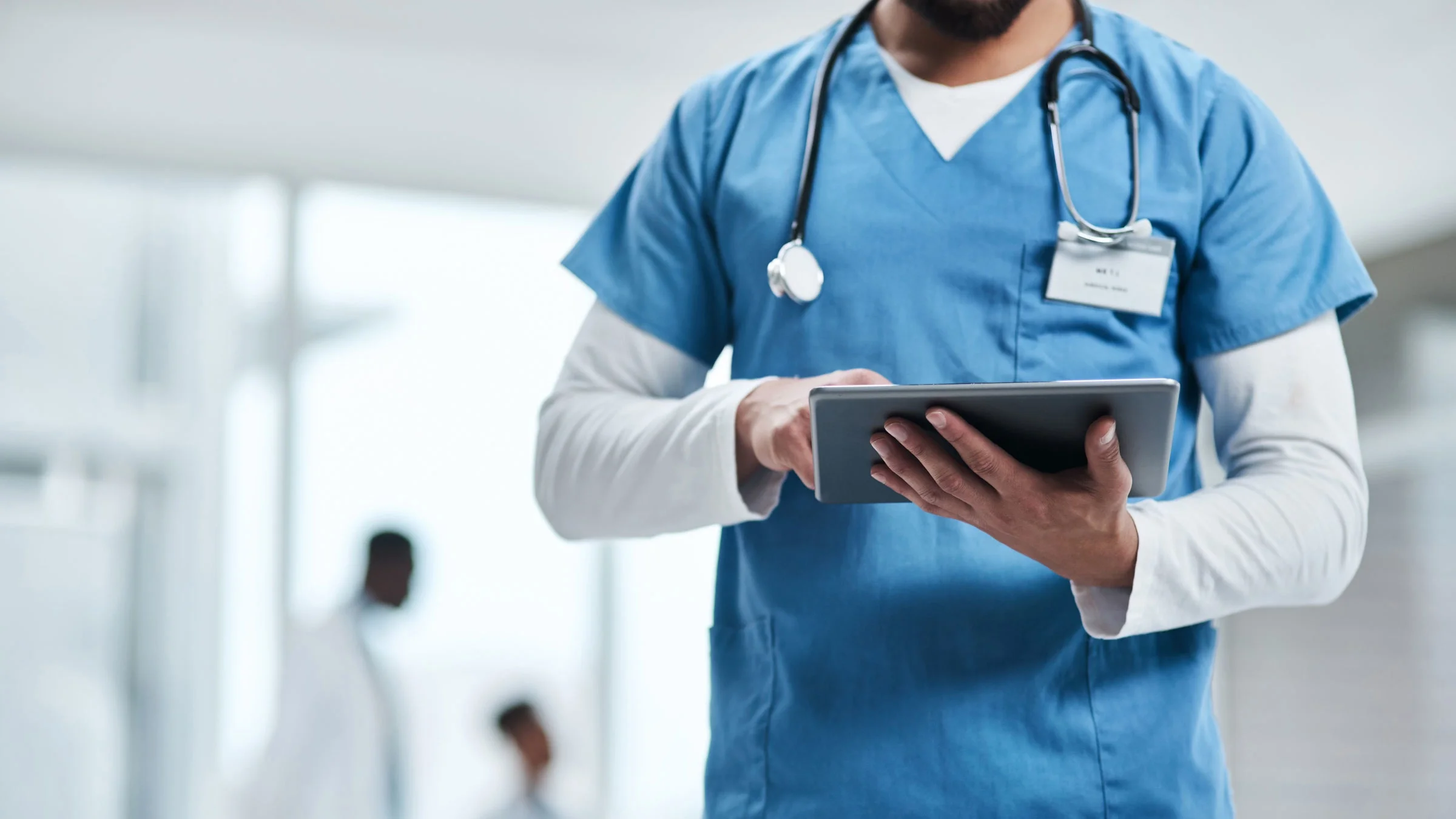 Close-up of healthcare professional with tablet.
