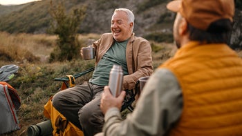 Health: heart health: senior men camping and having fun drinking coffee 1273010170