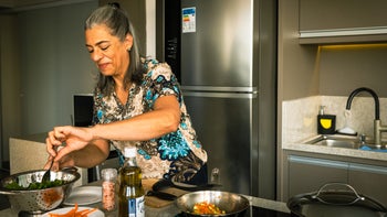 Womens health: woman making a meal at home 1428184801