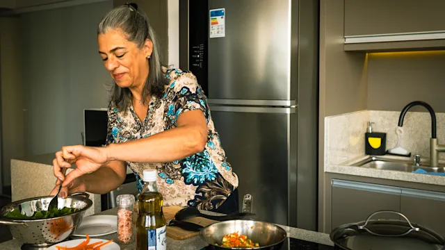 Womens health: woman making a meal at home 1428184801