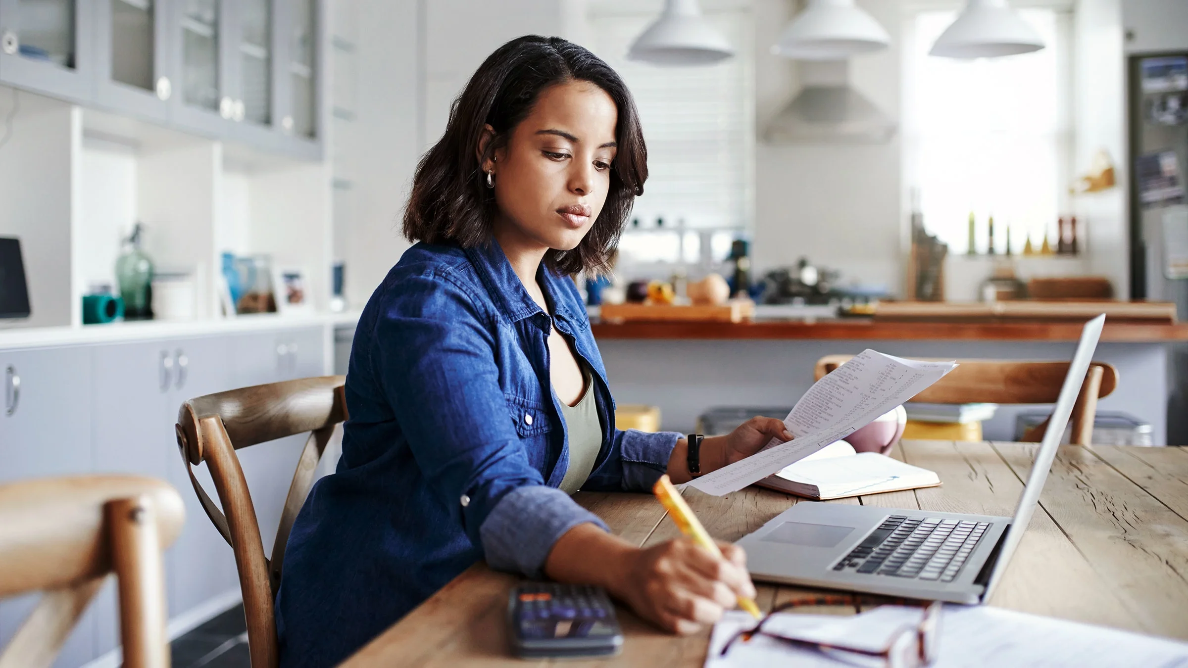 A woman works on her finances at home.