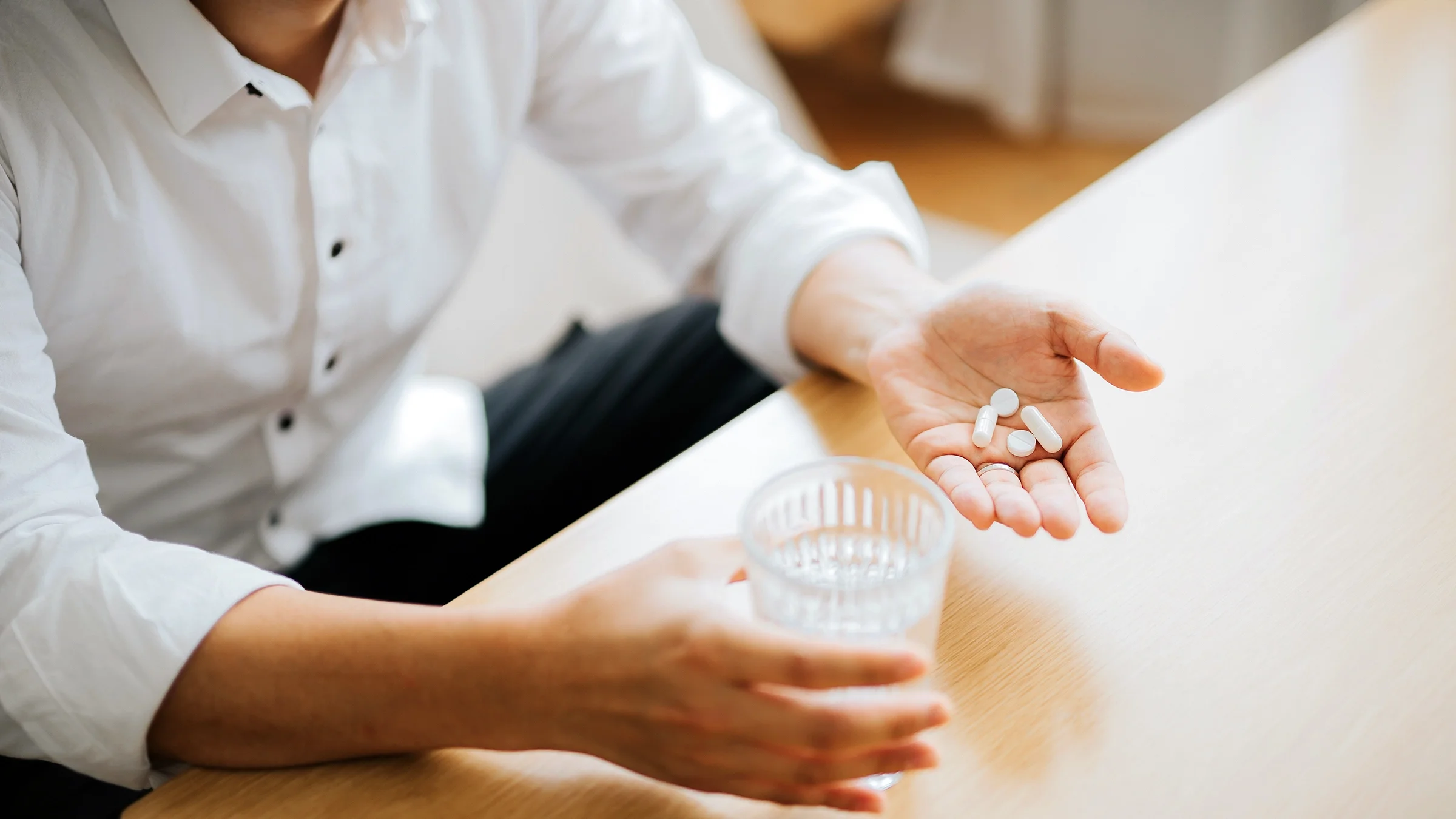 A close-up of prescription pills in a person’s hand.