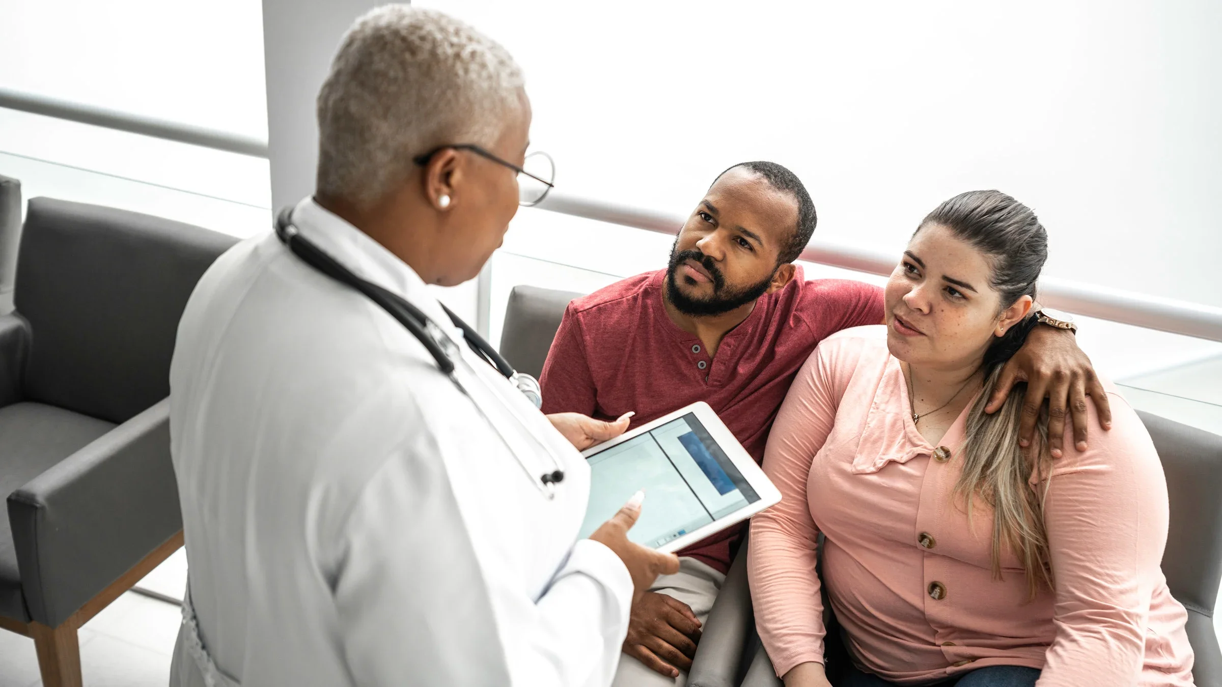 Weight: plus-size patient talking to doctor with spouse 1201195136