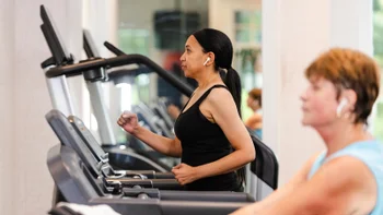 movement exercise: woman walking on treadmill 2167923072