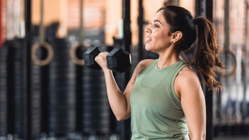 Health: movement-exercise: woman lifting weights at gym 1320391277
