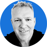 Black and white image of Dave Dondaneau, with a blue background.