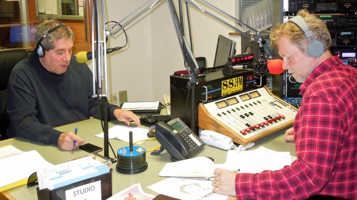 Bill Thompson is pictured with his co-host in a Cincinnati radio station studio doing their music show.