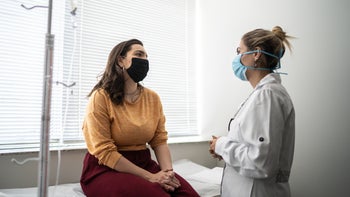 Abortion: Patient: Doctor: young woman consulting with doctor exam room 1341306602
